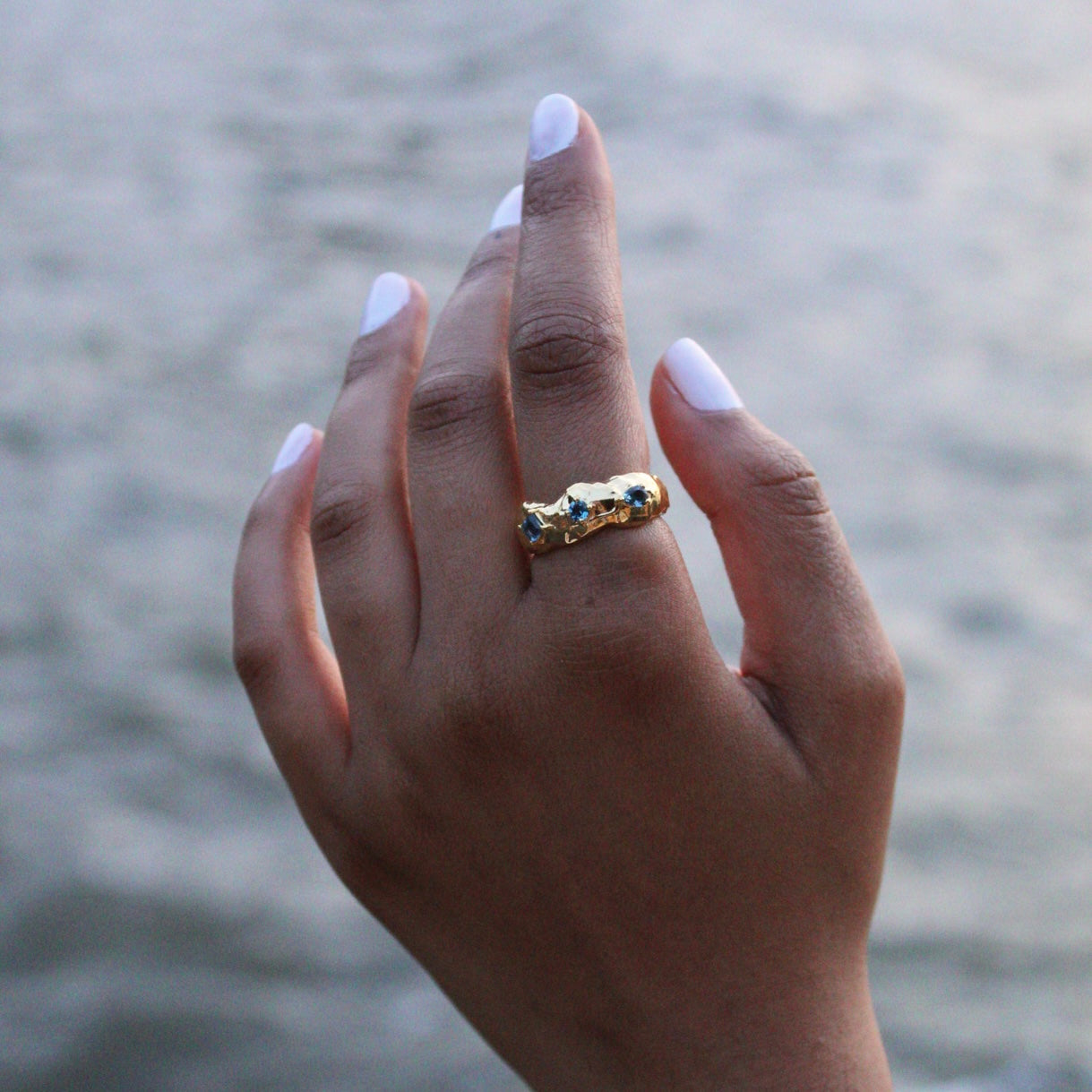 Asymmetrical Gold London Blue Topaz Ring on a Hand