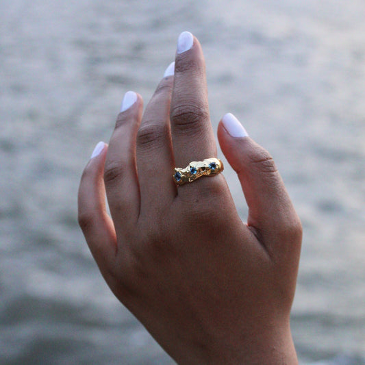 Asymmetrical Gold London Blue Topaz Ring on a Hand