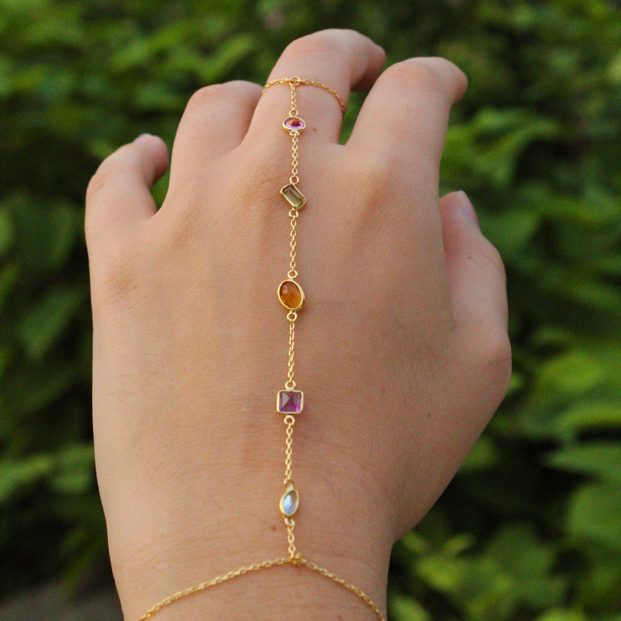 Colorful Gold Multi-Gemstone Handchain with different shapes of swiss blue topaz, pink topaz, citrine, peridot, and purple amethyst